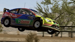 Rally car leaping over a small bush