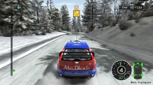Rally car driving down a snowy road