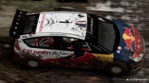 Rally car covered in dirt, viewed from above