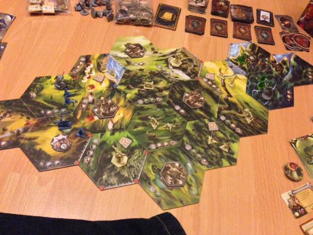 A Basic two player map of Runewars setup for play. The Daqan Lords are the blue minis on the left with the Latari elves the Green on the right.