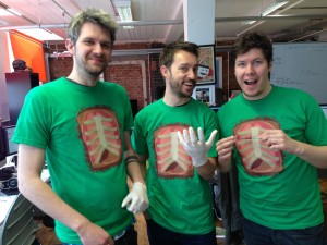 Surgeon Sim T-shirts modelled by  developers Tom Jackson, James Broadley and Luke Williams of Bossa Studios